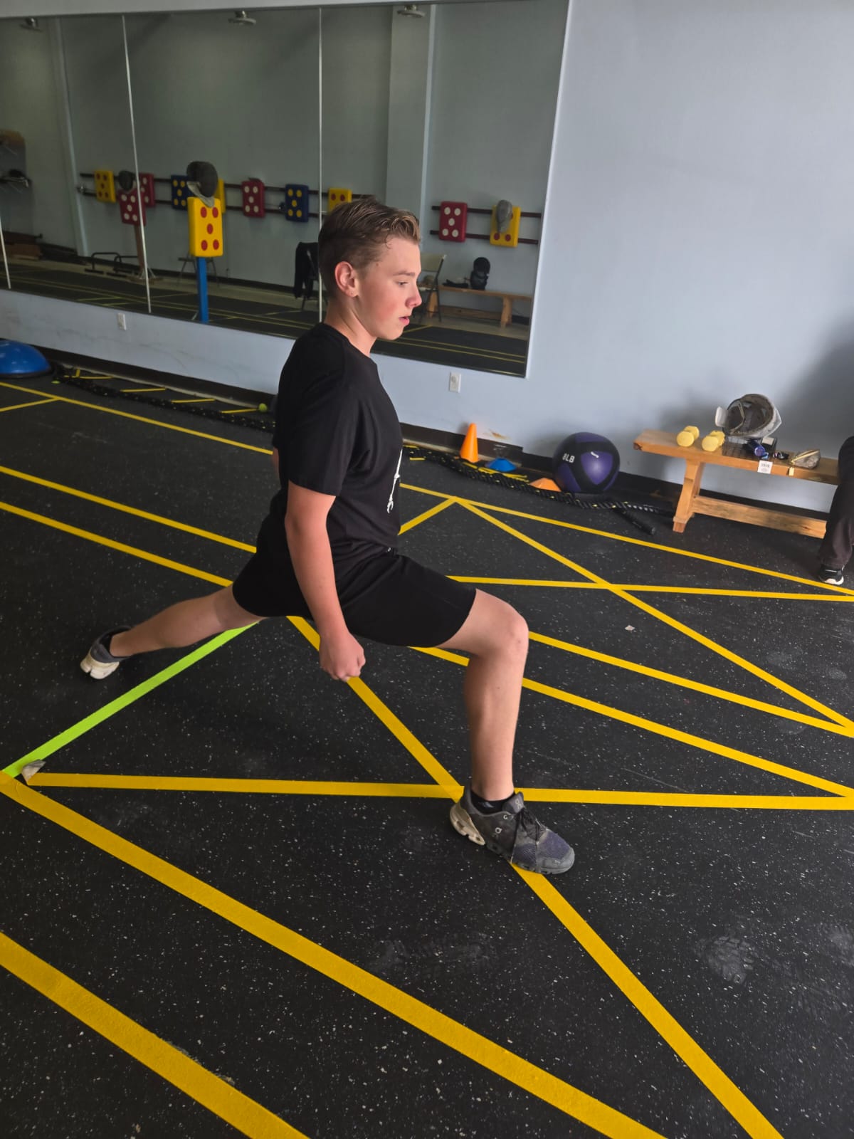 Teen fencer stretching before training