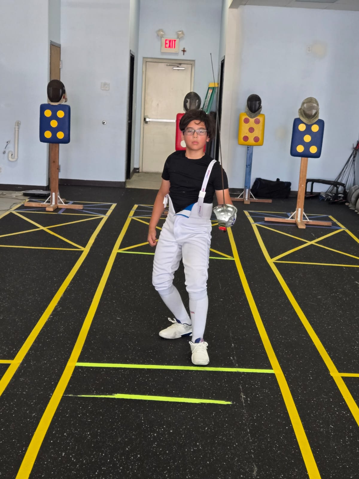 Young fencer walking the strip