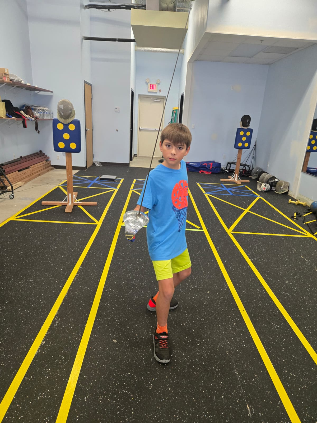 Kid fencer holding sabre