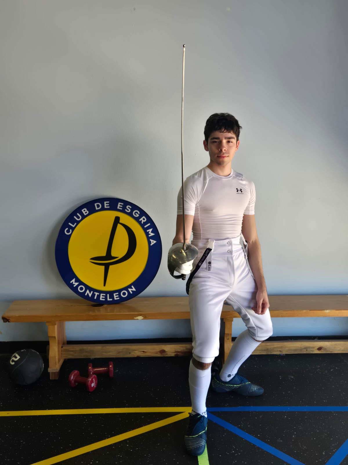Athlete standing beside the Monteleón logo