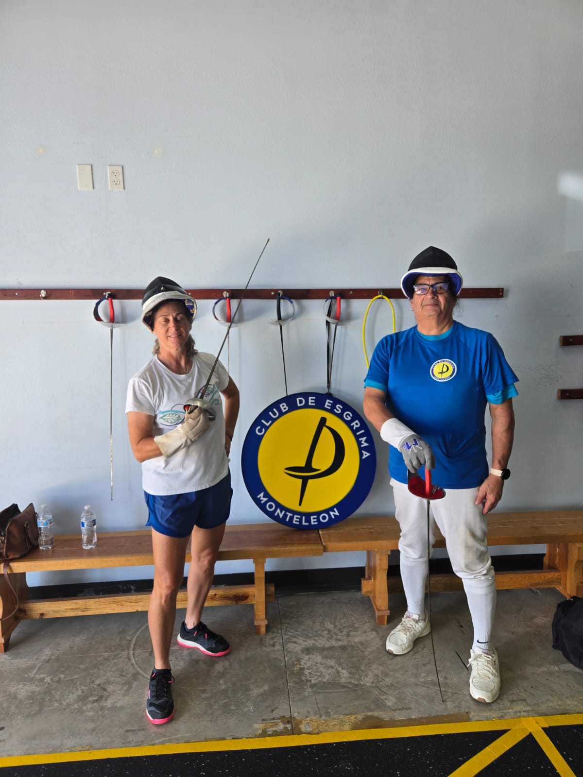 Adults posing with club logo